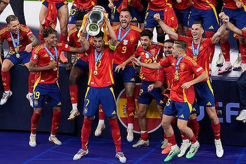 Spain's Alvaro Morata lifts the trophy
